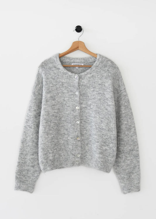 Gray cardigan on a hanger against a white background