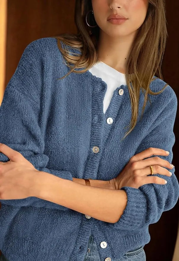 Woman wearing a blue cardigan with a blurred background