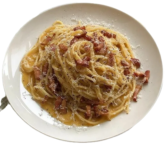 Spaghetti dish with bacon on a white plate