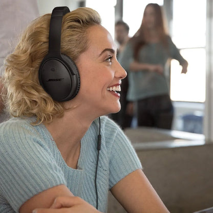 Woman wearing Bose headphones in a casual indoor setting