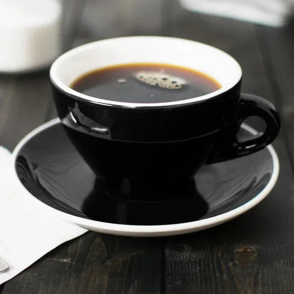 Black coffee cup with saucer on a wooden table