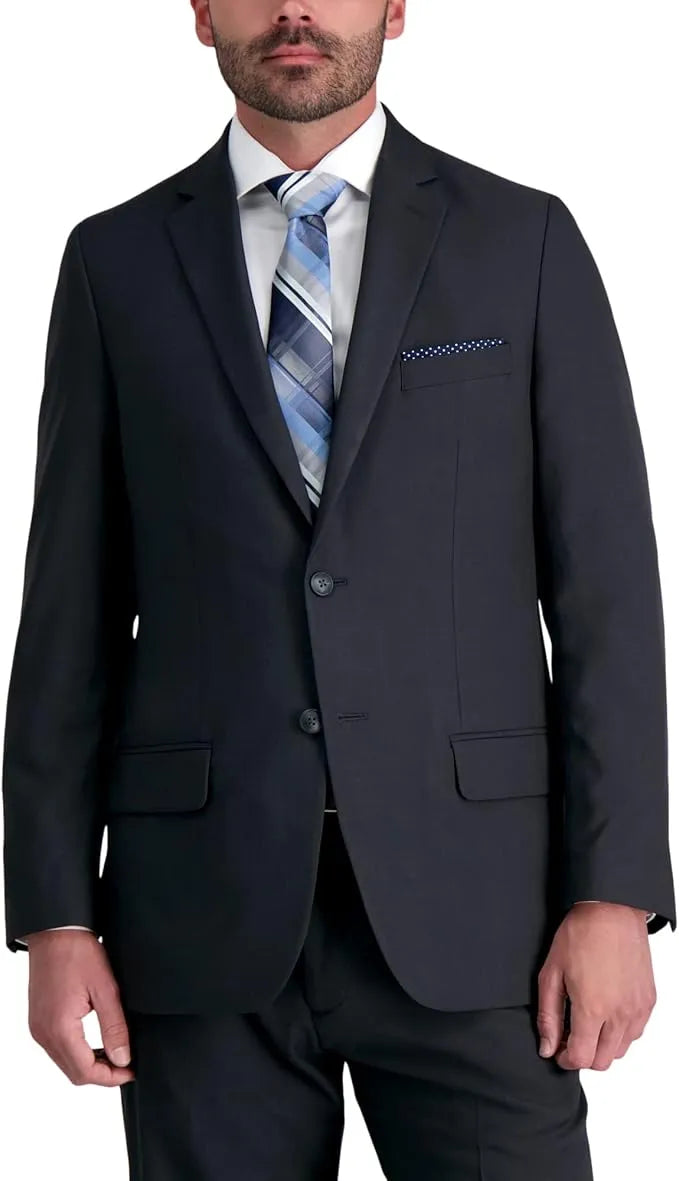 Man wearing a navy suit jacket with a white shirt and blue tie on a white background