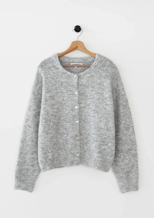 Gray cardigan on a hanger against a white background