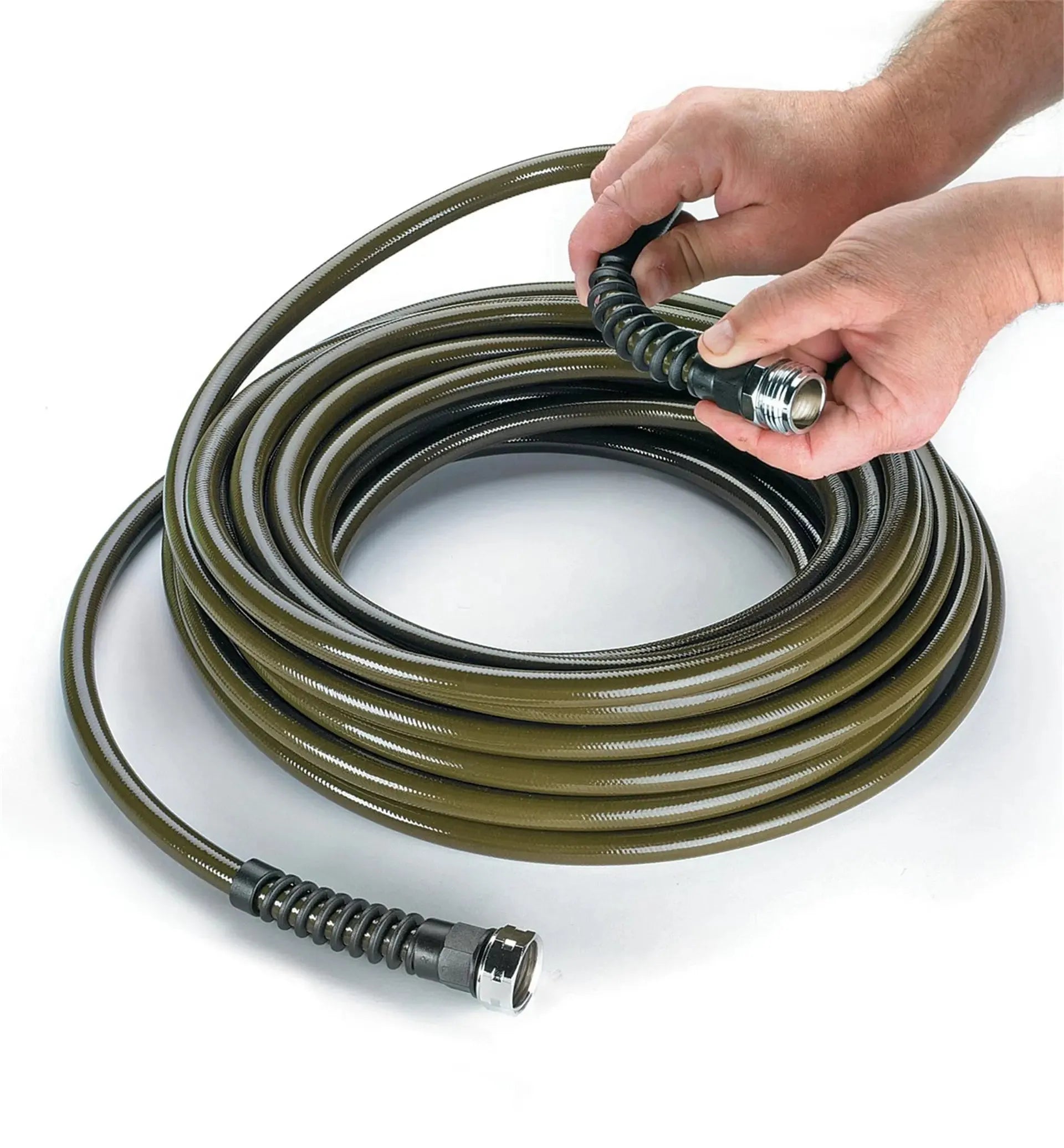 Coiled garden hose with a hand holding one end on a white background