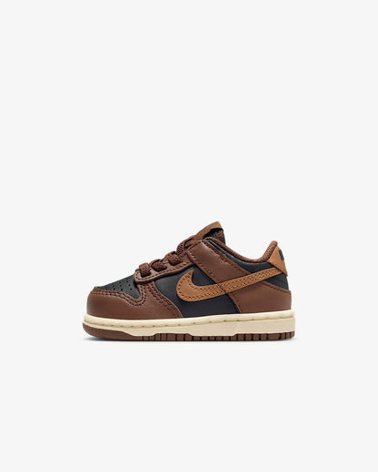 Brown and black sneaker with Nike logo on a white background